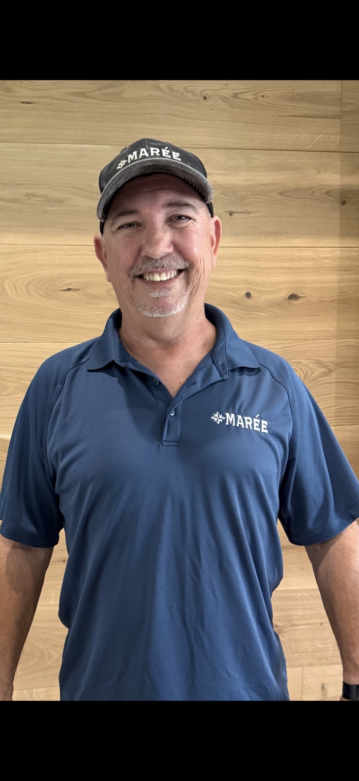Billy Maree, founder of Marée Hardwood Flooring, smiling in his company shirt and cap