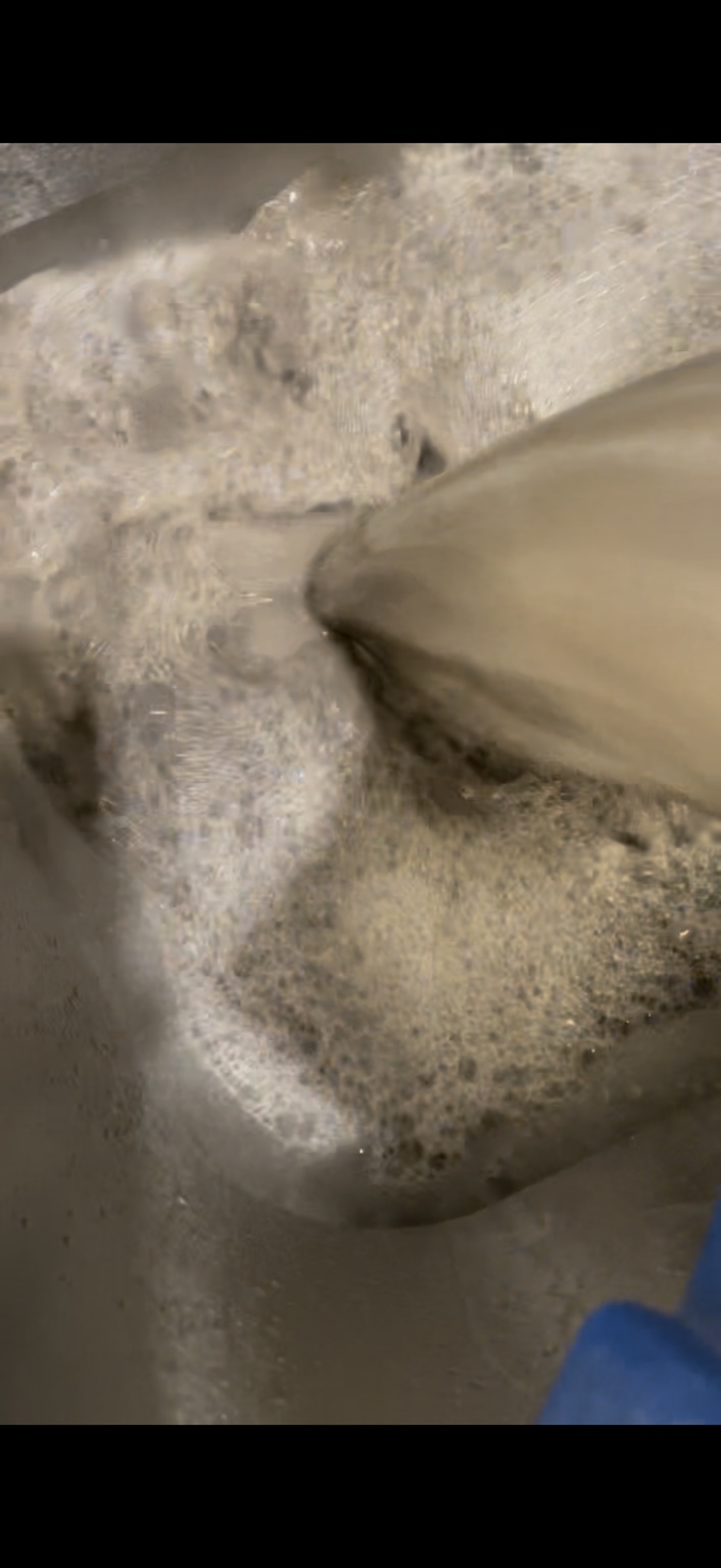 Collected dirty water and foam from the floor cleaning process