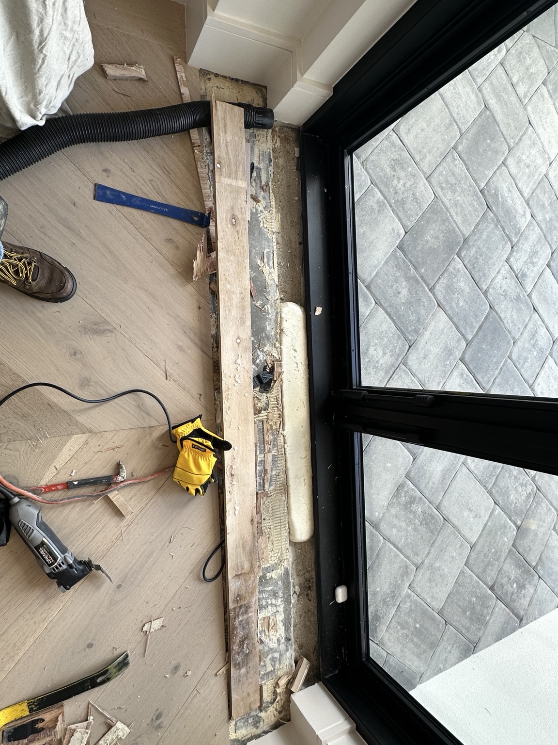 Removal of wood flooring at the entryway threshold