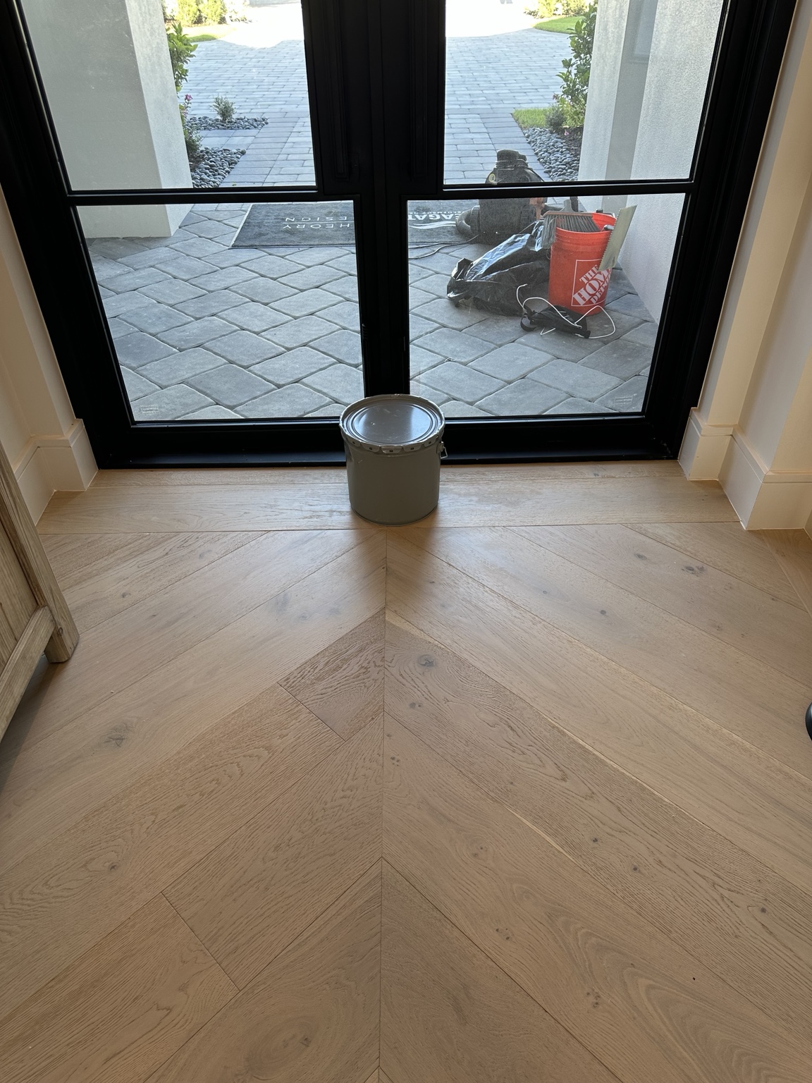 Completed wood floor repair beside the chevron flooring