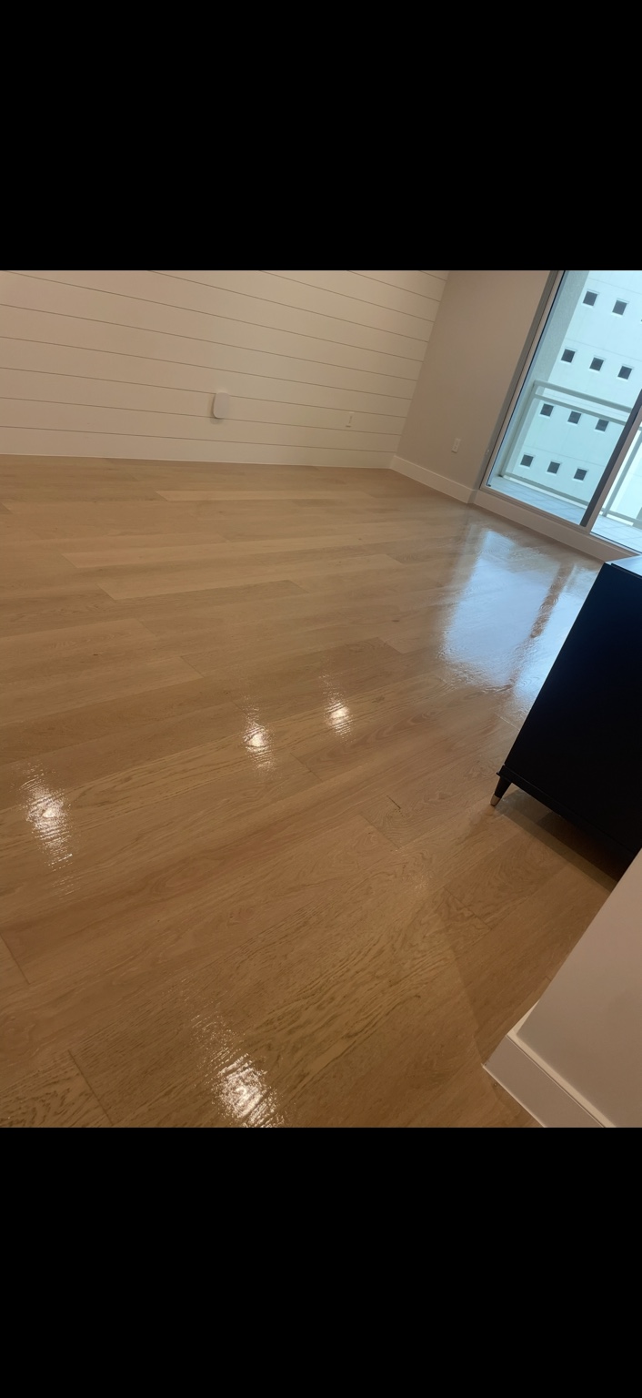 Glossy polyurethane top coat on warm wood flooring